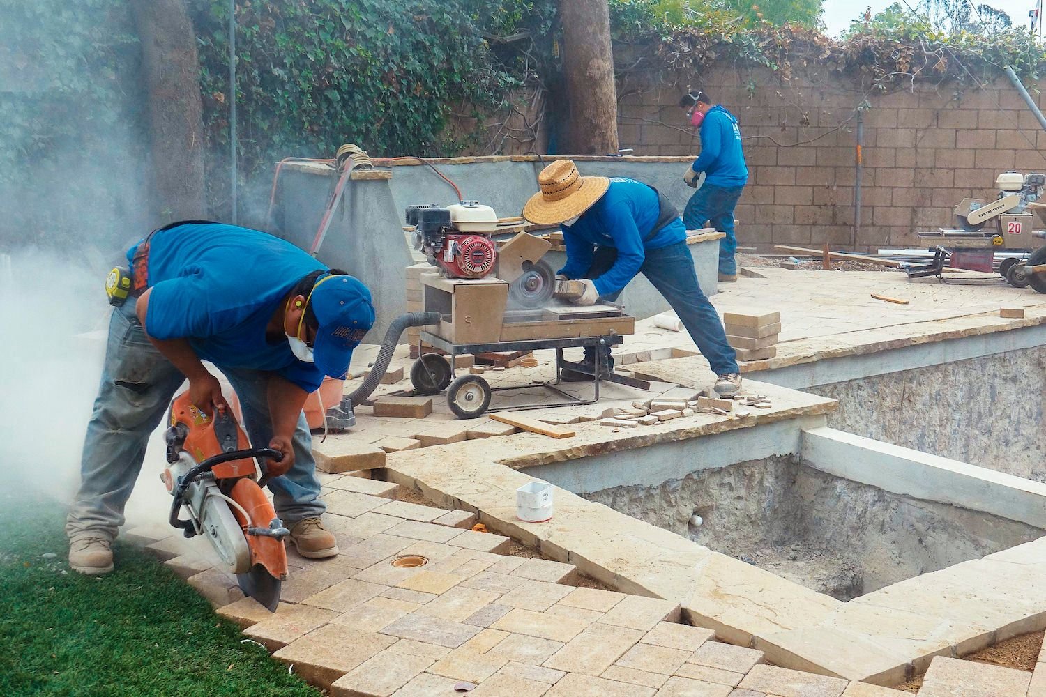 Certified Pavers from Rocket Estate Builders renovating a backyard pool area in Central Florida